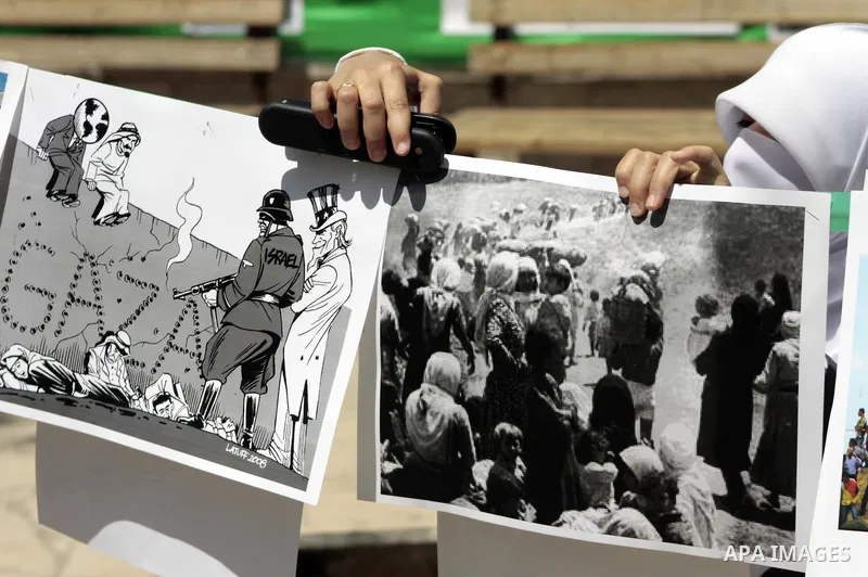 Palestinian Hamas supporters organize a photo gallery for practices of Israeli occupation soldiers and the 44th anniversary of 'Naksa,' Arabic for setback, during a protest in the West Bank city of Hebron on June 05, 201...