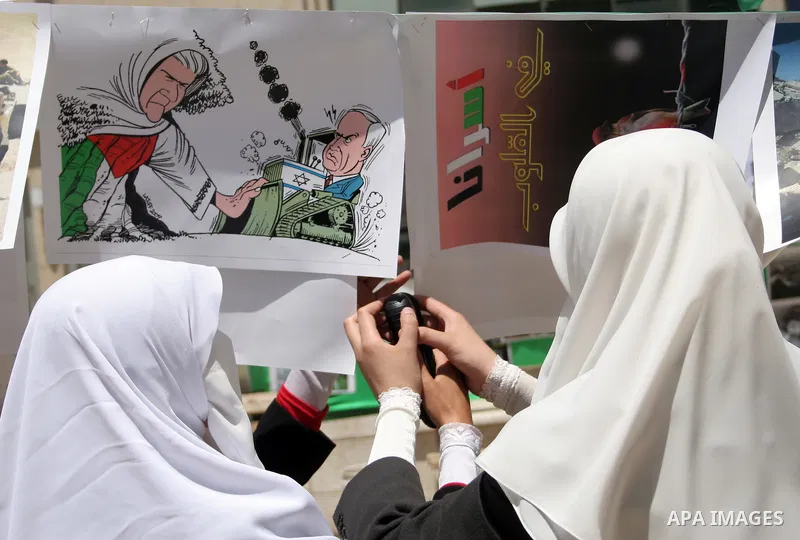 Palestinian Hamas supporters organize a photo gallery for practices of Israeli occupation soldiers and the 44th anniversary of 'Naksa,' Arabic for setback, during a protest in the West Bank city of Hebron on June 05, 201...