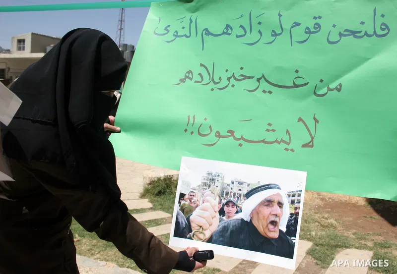 Palestinian Hamas supporters organize a photo gallery for practices of Israeli occupation soldiers and the 44th anniversary of 'Naksa,' Arabic for setback, during a protest in the West Bank city of Hebron on June 05, 201...