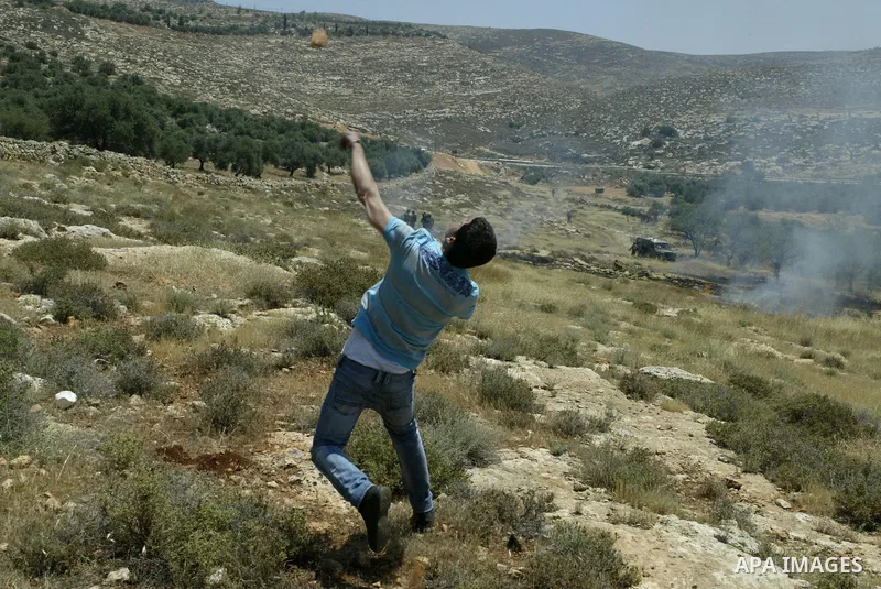 Palestinian protestors clash with Israeli forces following a demonstration against Israeli settlements in the West Bank village of Dair al-Hatab, east of Nablus, on June 5, 2011 as Israeli security forces go on high aler...