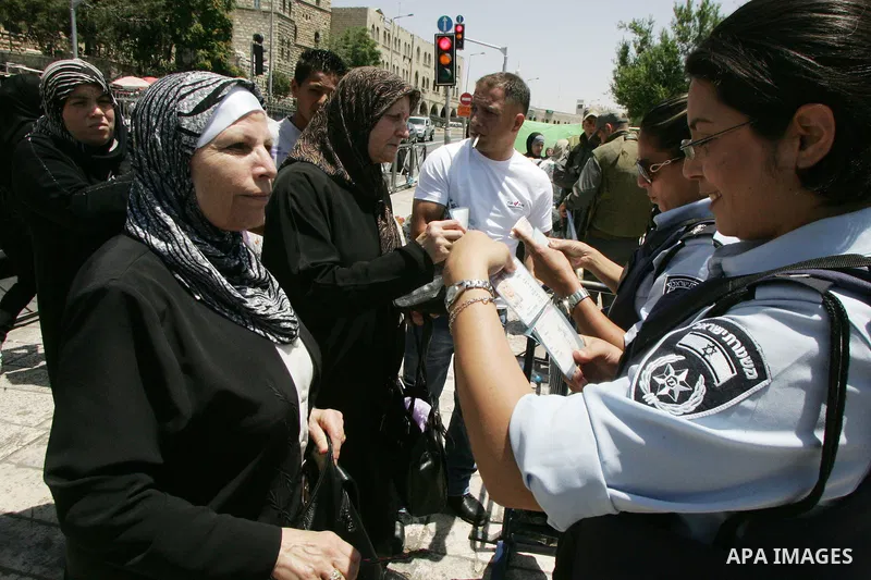 Israeli soldiers stand gurd as Palestinians take part in a protest at Damascus Gate, the main entrance to the old city of Jerusalem, on June 5, 2011 as Israeli security forces go on high alert while Palestinian activists...