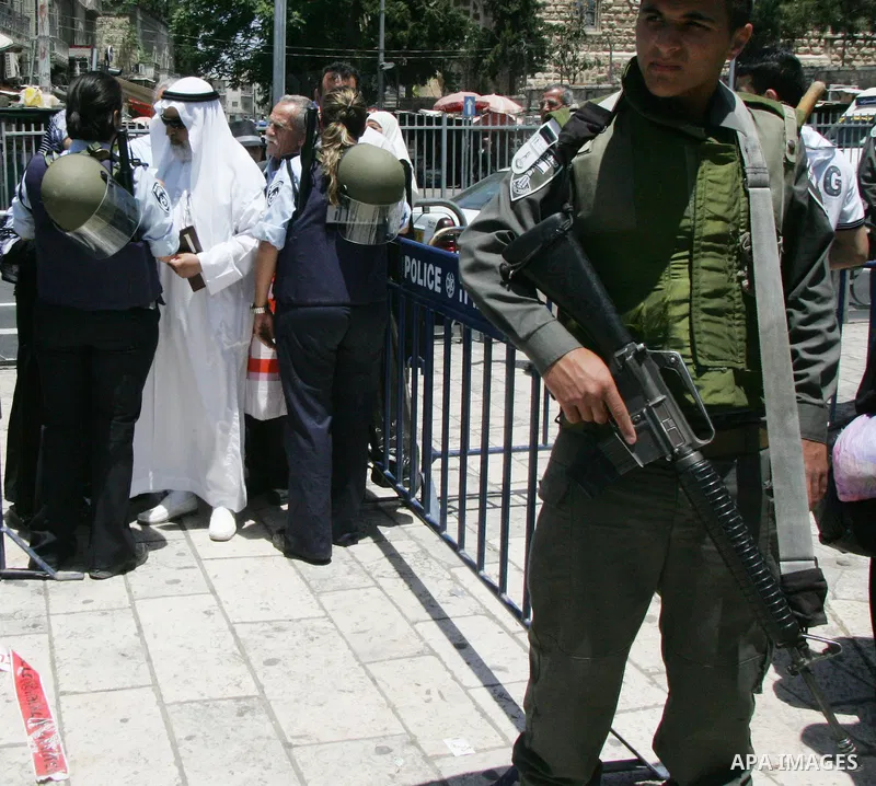 Israeli soldiers stand gurd as Palestinians take part in a protest at Damascus Gate, the main entrance to the old city of Jerusalem, on June 5, 2011 as Israeli security forces go on high alert while Palestinian activists...