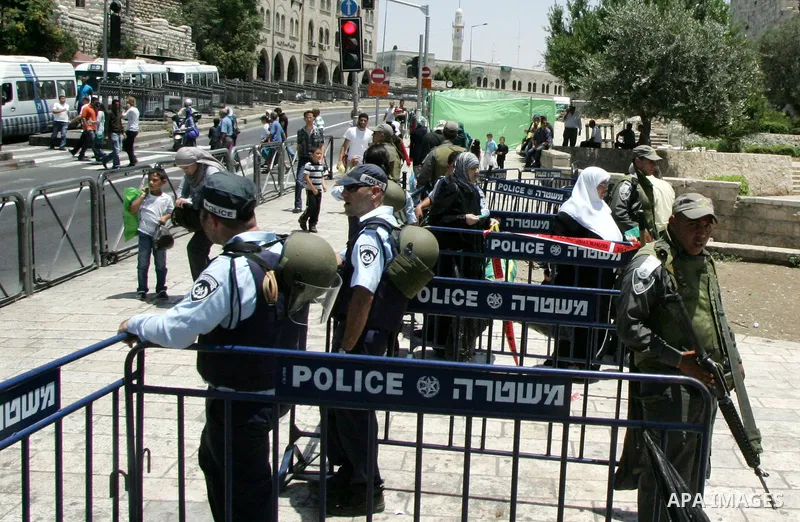 Israeli soldiers stand gurd as Palestinians take part in a protest at Damascus Gate, the main entrance to the old city of Jerusalem, on June 5, 2011 as Israeli security forces go on high alert while Palestinian activists...