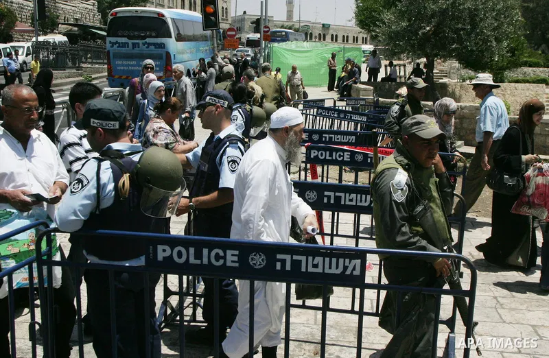 Israeli soldiers stand gurd as Palestinians take part in a protest at Damascus Gate, the main entrance to the old city of Jerusalem, on June 5, 2011 as Israeli security forces go on high alert while Palestinian activists...