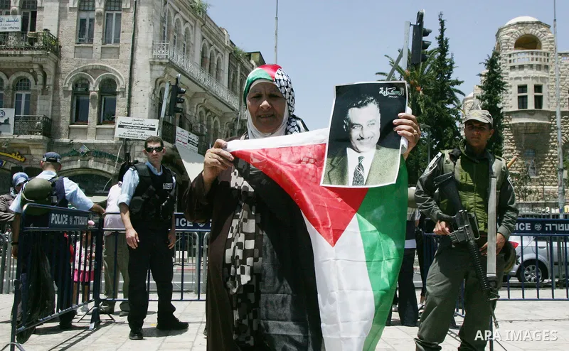 Israeli soldiers stand gurd as Palestinians take part in a protest at Damascus Gate, the main entrance to the old city of Jerusalem, on June 5, 2011 as Israeli security forces go on high alert while Palestinian activists...