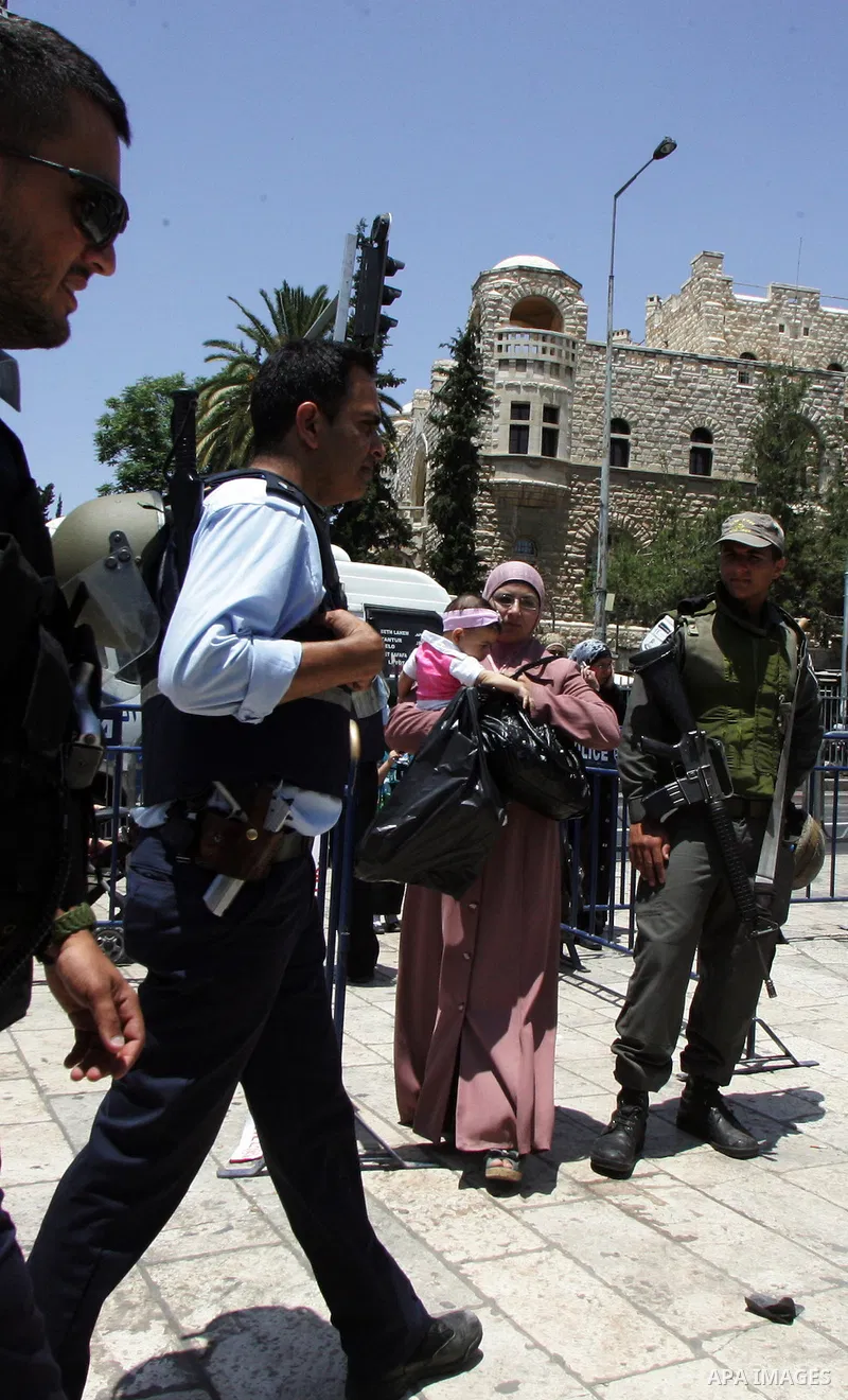 Israeli soldiers stand gurd as Palestinians take part in a protest at Damascus Gate, the main entrance to the old city of Jerusalem, on June 5, 2011 as Israeli security forces go on high alert while Palestinian activists...