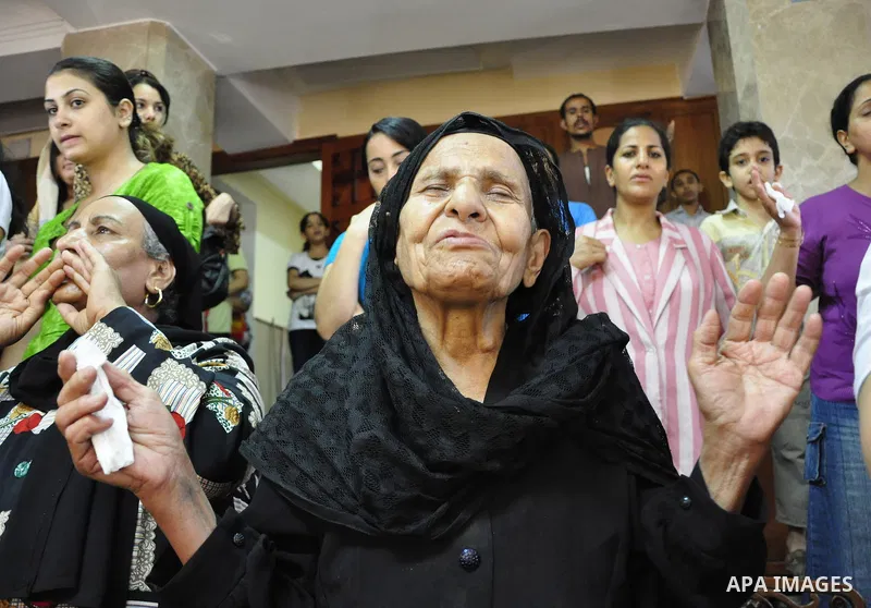 Egyptian Coptic Christians attend Sunday mass at the Virgin Mary church in the Imbaba district of the Egyptian capital of Cairo on June 5, 2011 following the church's restoration after it was burnt during clashes between...