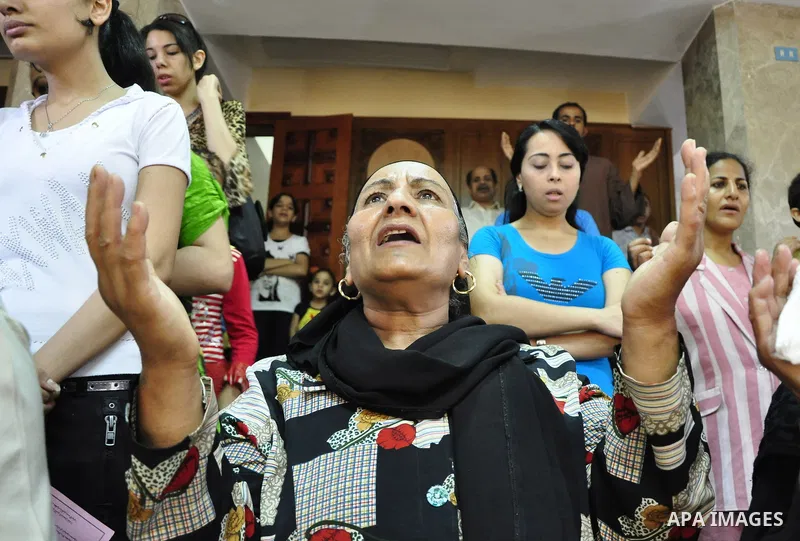 Egyptian Coptic Christians attend Sunday mass at the Virgin Mary church in the Imbaba district of the Egyptian capital of Cairo on June 5, 2011 following the church's restoration after it was burnt during clashes between...