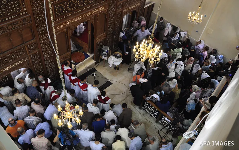 Egyptian Coptic Christians attend Sunday mass at the Virgin Mary church in the Imbaba district of the Egyptian capital of Cairo on June 5, 2011 following the church's restoration after it was burnt during clashes between...