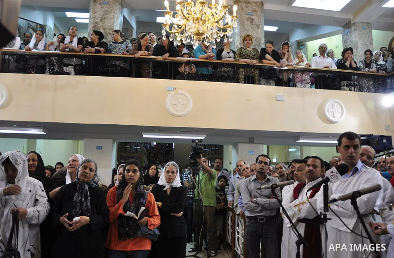 Egyptian Coptic Christians attend Sunday mass at the Virgin Mary church in the Imbaba district of the Egyptian capital of Cairo on June 5, 2011 following the church's restoration after it was burnt during clashes between...