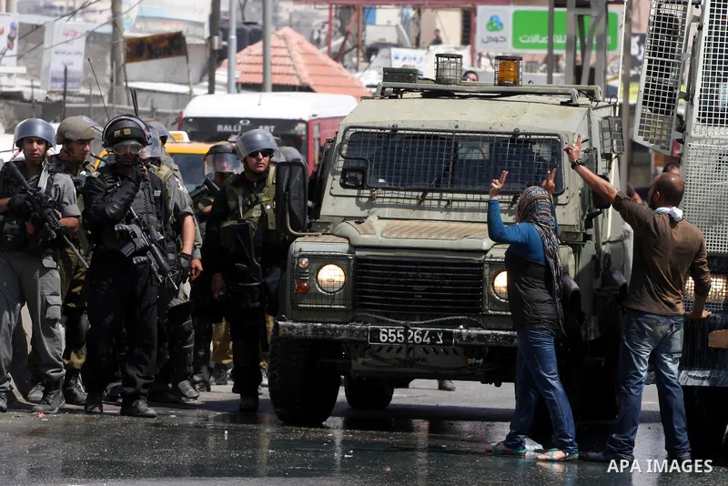Palestinian demonstrators scuffle with Israeli soldiers during a protest marking the 44th anniversary of the Six Days War on June 5, 2011 at the Israeli-controlled Qalandia checkpoint between Jerusalem and the West bank...