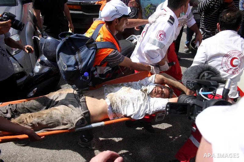 An injured man is carried away during a protest marking the 44th anniversary of the Six Days War on June 5, 2011 at the Israeli-controlled Qalandia checkpoint between Jerusalem and the West bank city of Ramallah. Photo b...