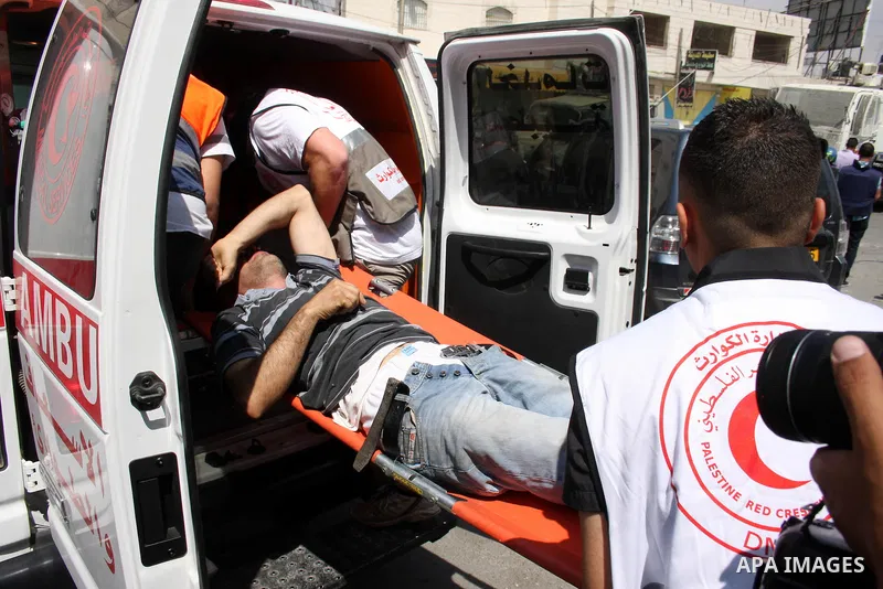 An injured man is carried away during a protest marking the 44th anniversary of the Six Days War on June 5, 2011 at the Israeli-controlled Qalandia checkpoint between Jerusalem and the West bank city of Ramallah. Photo b...