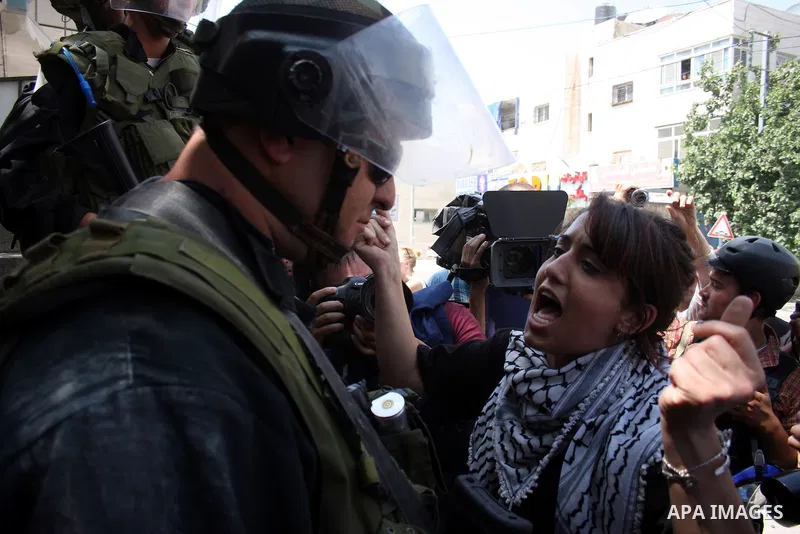 A Palestinian demonstrator scuffles with Israeli soldiers during a protest marking the 44th anniversary of the Six Days War on June 5, 2011 at the Israeli-controlled Qalandia checkpoint between Jerusalem and the West ban...