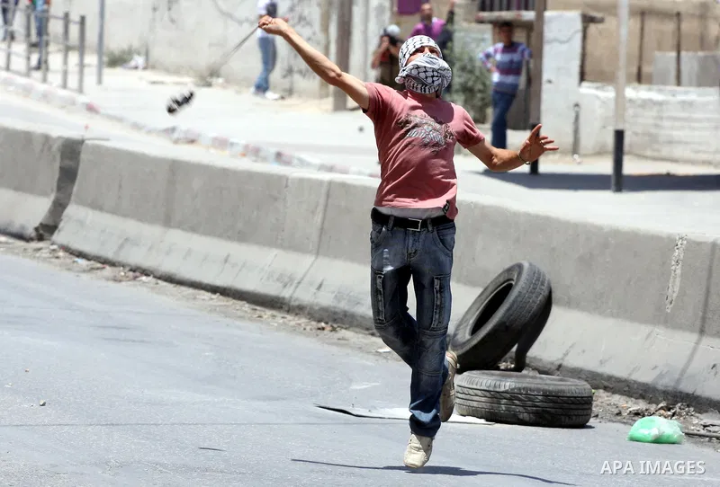 Palestinian demonstrators hurl stones at Israeli soldiers during clashes with Israeli troops at the Qalandia checkpoint, on June 5, 2011 between Jerusalem and the West Bank city of Ramallah. The clashes come on the 44th...