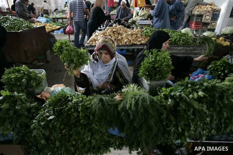 Palestinian women during showing fresh vegetables at a market in Rafah refugee camp in the southern Gaza Strip on June 6, 2011. Photo by Abed Rahim Khatib