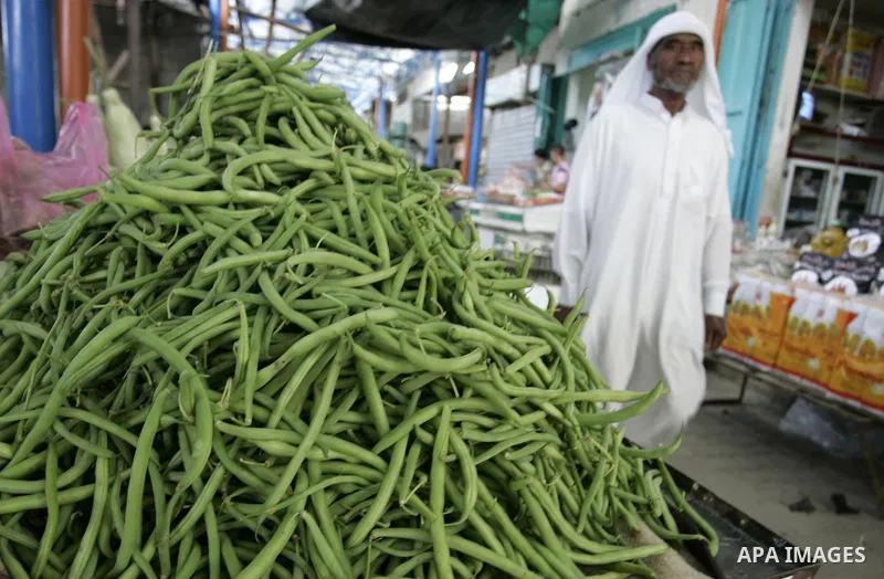 A Palestinian man displays beans in the market of Rafah refugee camp in the southern Gaza Strip on June 6, 2011. Photo by Abed Rahim Khatib