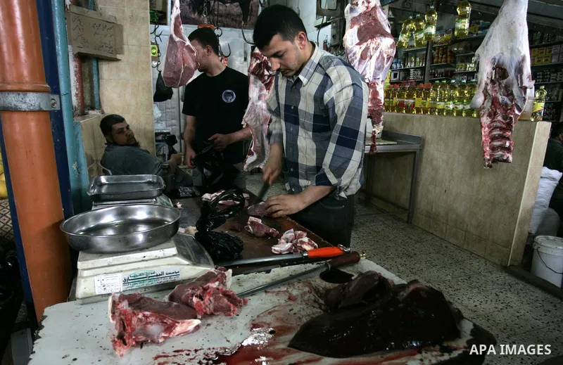 A Palestinian man sells beef in the market in Rafah refugee camp, southern Gaza Strip on June 7, 2011. Photo by Abed Rahim Khatib