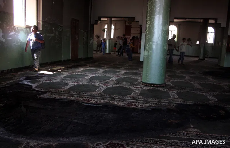 A Palestinian man inspects a partially burn mosque in the West Bank of al-Mughayyir village, some 20 kilometres (12 miles) northeast of Ramallah City on June 7, 2011. Palestinian security sources said Jewish settlers are...