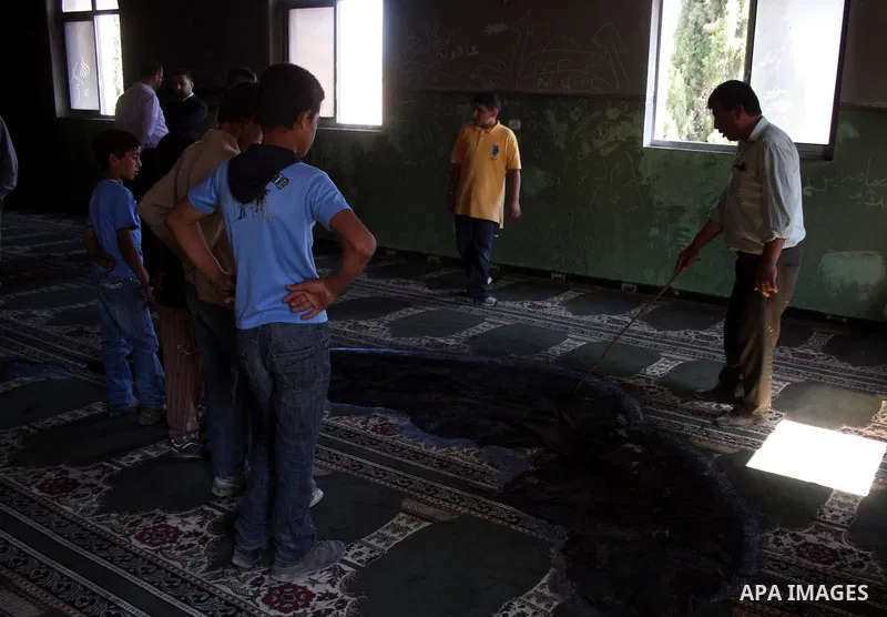 A Palestinian man inspects a partially burn mosque in the West Bank of al-Mughayyir village, some 20 kilometres (12 miles) northeast of Ramallah City on June 7, 2011. Palestinian security sources said Jewish settlers are...