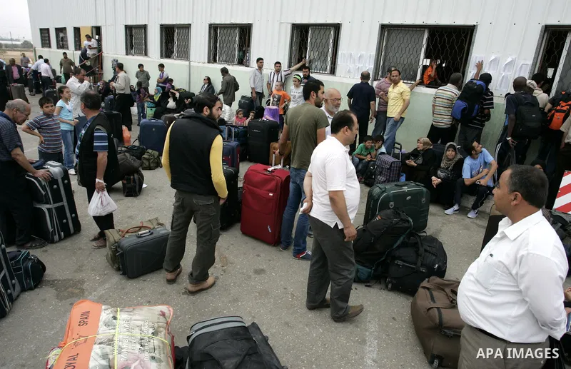 Palestinians load their luggage and wait to cross into Egypt through the Rafah border crossing in the southern Gaza Strip on June 8, 2011 after it was reopened, ending a four-day closure amid disagreements between Egypti...