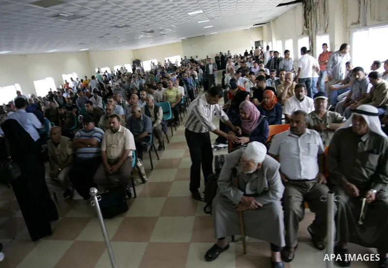 Palestinians wait to cross into Egypt through the Rafah border crossing in the southern Gaza Strip on June 8, 2011 after it was reopened, ending a four-day closure amid disagreements between Egyptian and Hamas officials....