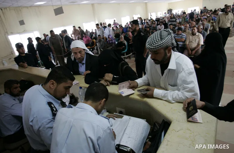 Palestinians border police check documents of travellers waiting to cross into Egypt through the Rafah border crossing in the southern Gaza Strip on June 8, 2011 after it was reopened, ending a four-day closure amid disa...