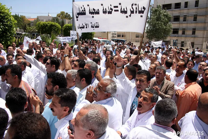 Palestinian doctors protest in front of the Prime Minister Salam Fayyad office in the West Bank city of Ramallah, Wednesday on June 8, 2011 as the Palestinian High Court decided to stop the strike. Photo by Issam Rimawi