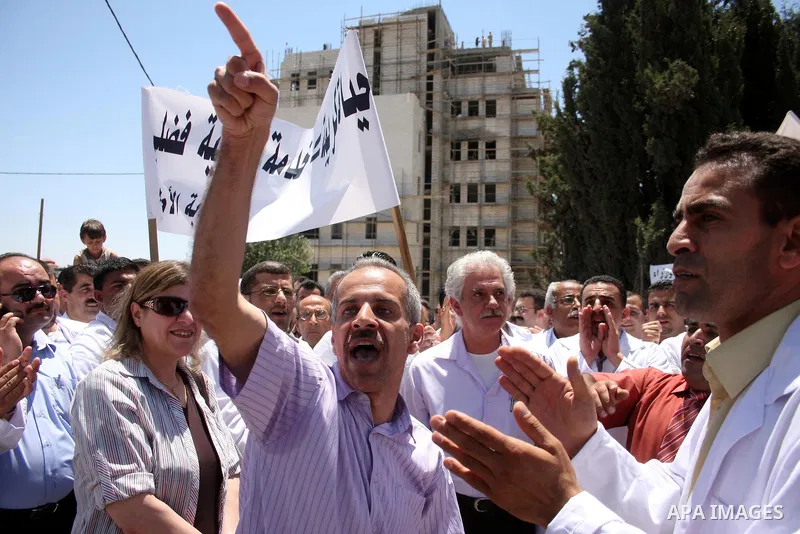 Palestinian doctors protest in front of the Prime Minister Salam Fayyad office in the West Bank city of Ramallah, Wednesday on June 8, 2011 as the Palestinian High Court decided to stop the strike. Photo by Issam Rimawi