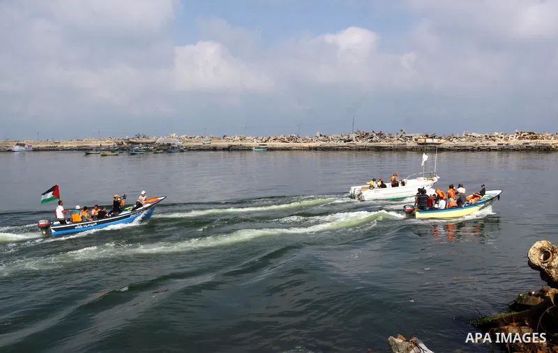 Foreign activists ride their Oliva boat to monitor the violations of the Israeli forces against the Palestinian fishermen in the Mediterranean Sea off the coast of Gaza City on June 8,2011.. Photo by Mohammed Asad
