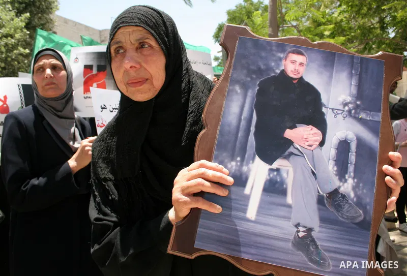 Palestinian Hamas supporters hold up pictures of relatives who were arrested and imprisoned for political reasons by Palestinian Authority security forces, during a protest in the West Bank city of Hebron, on June 09,201...