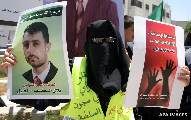 Palestinian Hamas supporters hold up pictures of relatives who were arrested and imprisoned for political reasons by Palestinian Authority security forces, during a protest in the West Bank city of Hebron, on June 09,201...