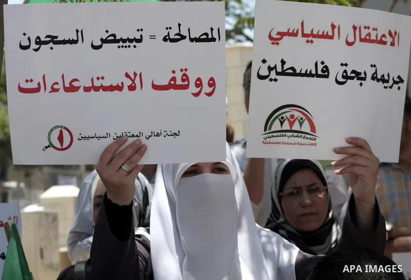 Palestinian Hamas supporters hold up pictures of relatives who were arrested and imprisoned for political reasons by Palestinian Authority security forces, during a protest in the West Bank city of Hebron, on June 09,201...