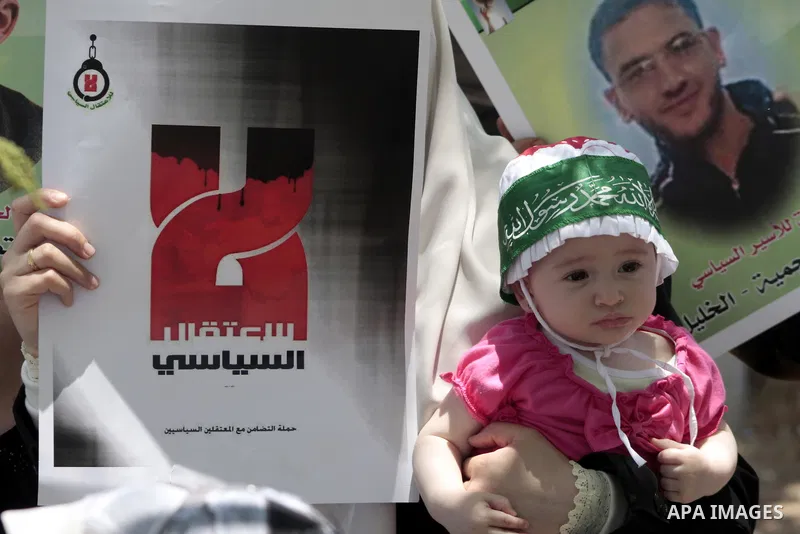 Palestinian Hamas supporters hold up pictures of relatives who were arrested and imprisoned for political reasons by Palestinian Authority security forces, during a protest in the West Bank city of Hebron, on June 09,201...