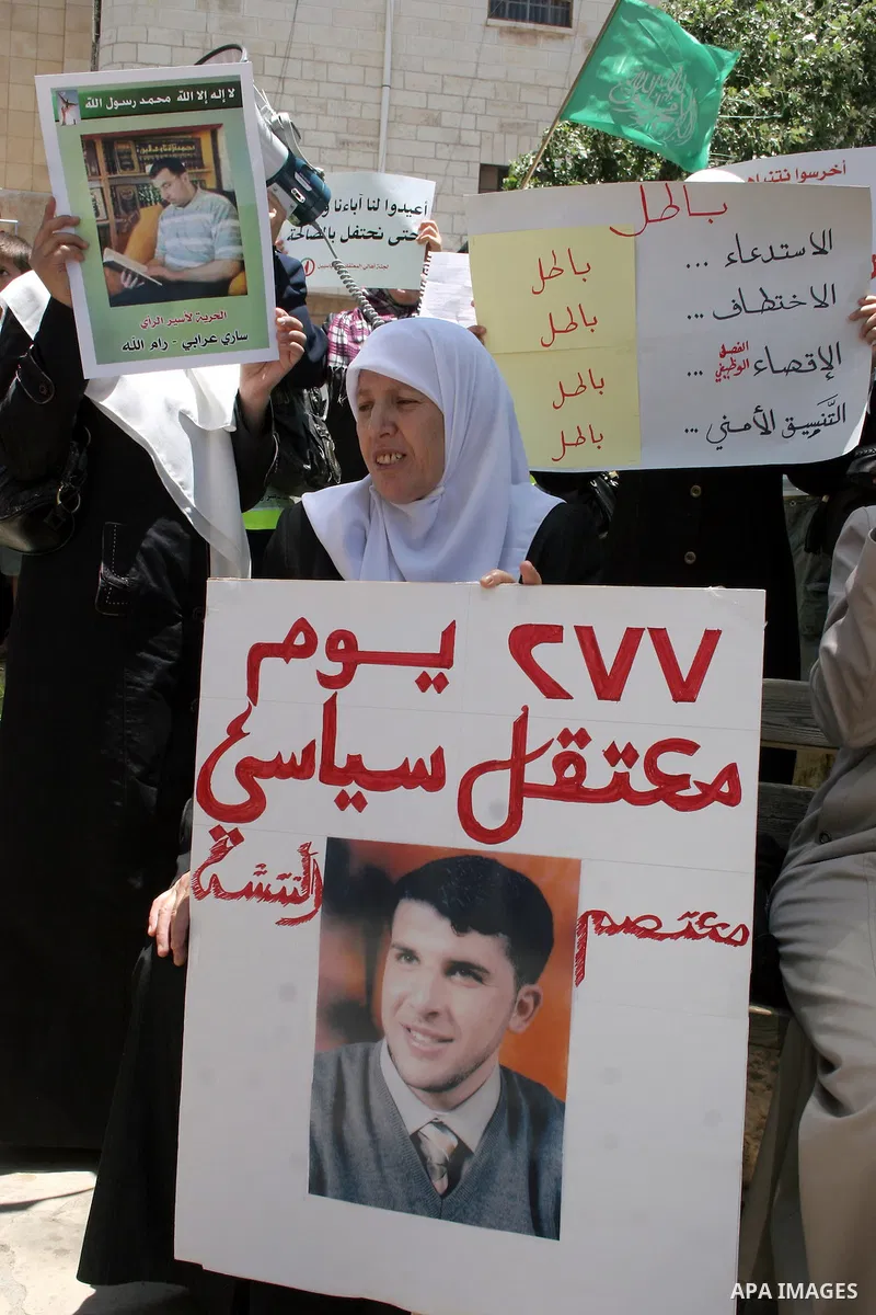 Palestinian Hamas supporters hold up pictures of relatives who were arrested and imprisoned for political reasons by Palestinian Authority security forces, during a protest in the West Bank city of Hebron, on June 09,201...