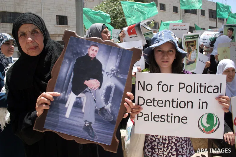 Palestinian Hamas supporters hold up pictures of relatives who were arrested and imprisoned for political reasons by Palestinian Authority security forces, during a protest in the West Bank city of Hebron, on June 09,201...