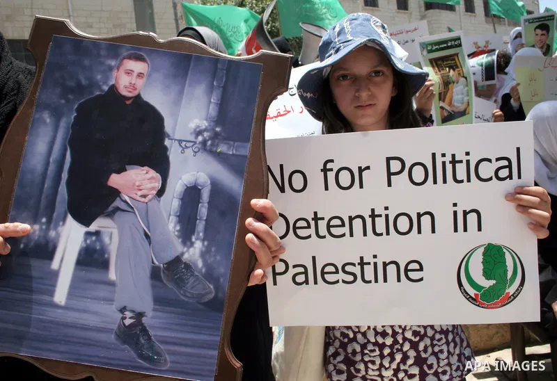 Palestinian Hamas supporters hold up pictures of relatives who were arrested and imprisoned for political reasons by Palestinian Authority security forces, during a protest in the West Bank city of Hebron, on June 09,201...