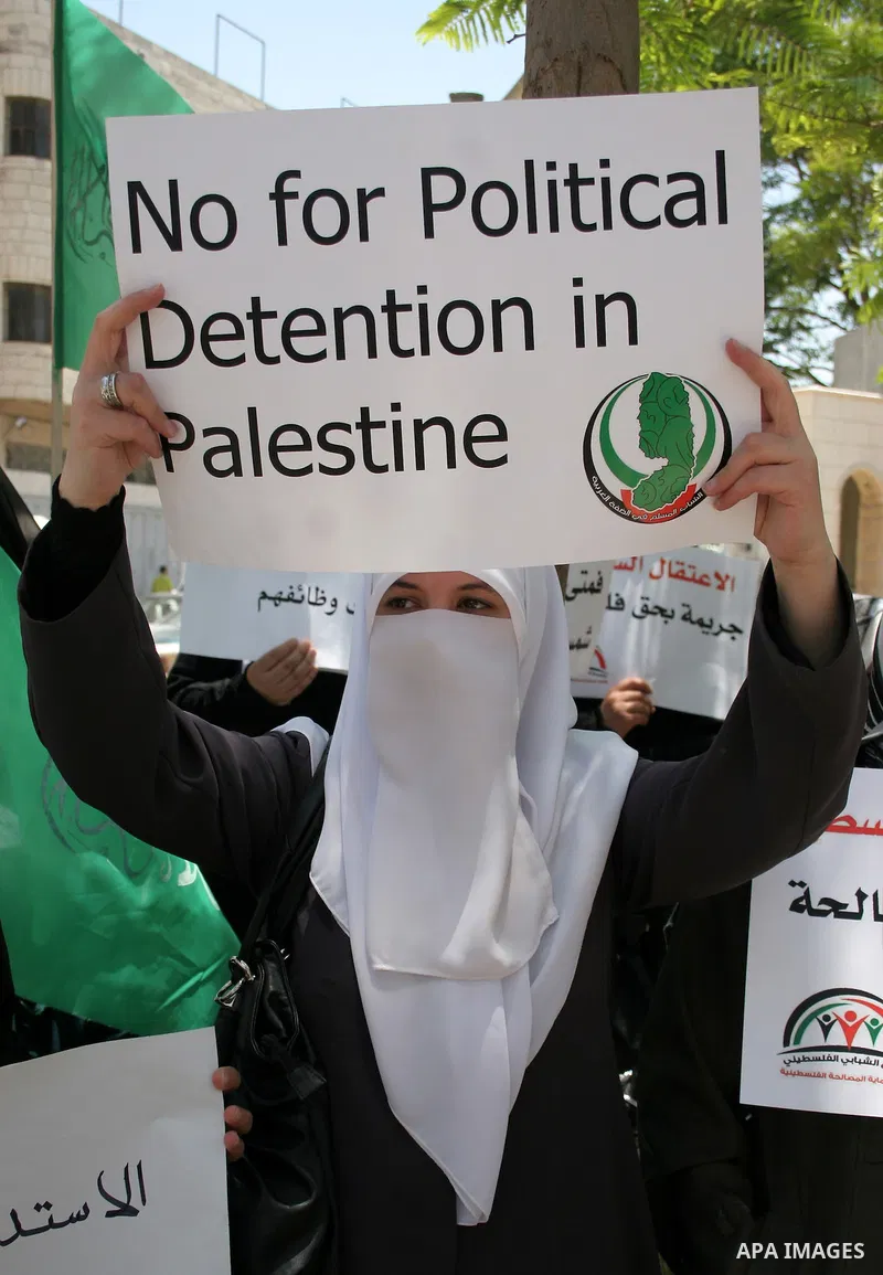 Palestinian Hamas supporters hold up pictures of relatives who were arrested and imprisoned for political reasons by Palestinian Authority security forces, during a protest in the West Bank city of Hebron, on June 09,201...