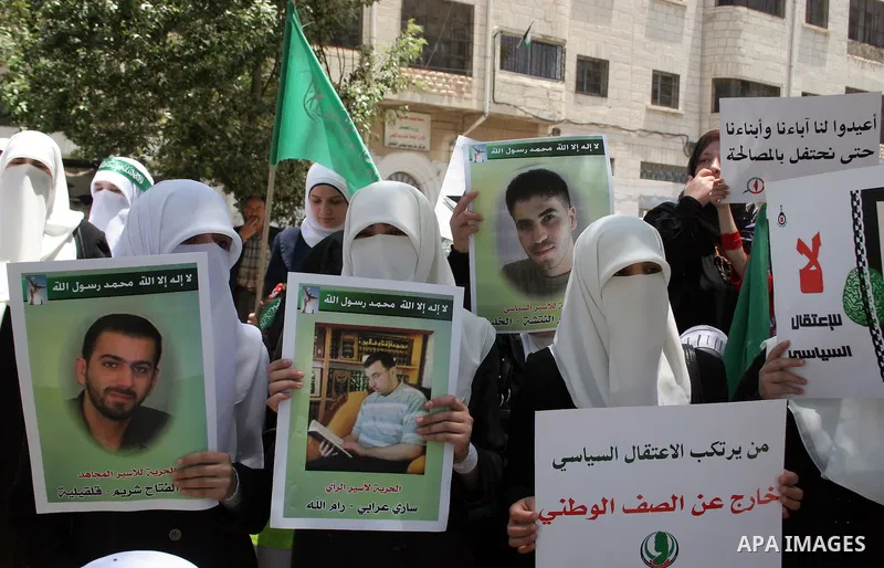 Palestinian Hamas supporters hold up pictures of relatives who were arrested and imprisoned for political reasons by Palestinian Authority security forces, during a protest in the West Bank city of Hebron, on June 09,201...