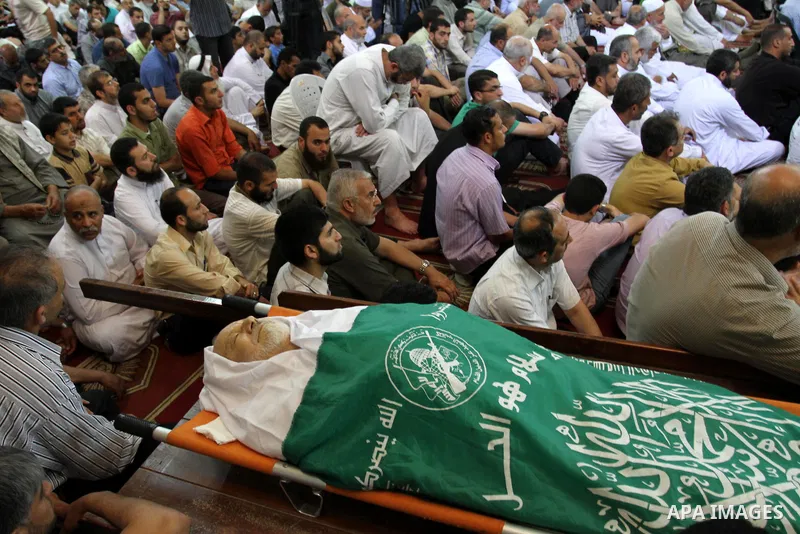 Palestinians attend Friday prayers next to the body of Mohammed Shamaa, one of the Hamas Movement founders, at Omari mosque in Gaza city on June 10,2011. Photo by Mohammed Asad