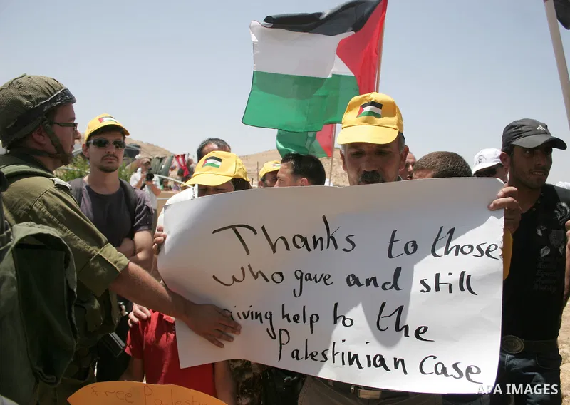 Israeli forces disperse a demonstration by Palestinian and foreign peace activists against Israeli settlements in the West Bank village of Al-Tuwani, near Hebron, on June 10,2011. Photo by Najeh Hashlamoun .