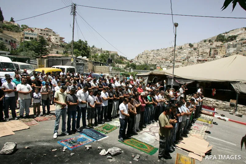 Palestinian Muslim worshippers attend Friday prayers near a protest tent in the mostly Arab neighbourhood of Silwan in east Jerusalem on June 10, 2011. Photo by Mahfouz Abu Turk