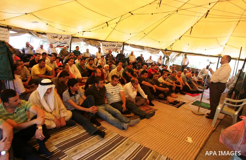 Palestinian Muslim worshippers attend Friday prayers inside a protest tent in the mostly Arab neighbourhood of Silwan in east Jerusalem on June 10, 2011. Photo by Mahfouz Abu Turk