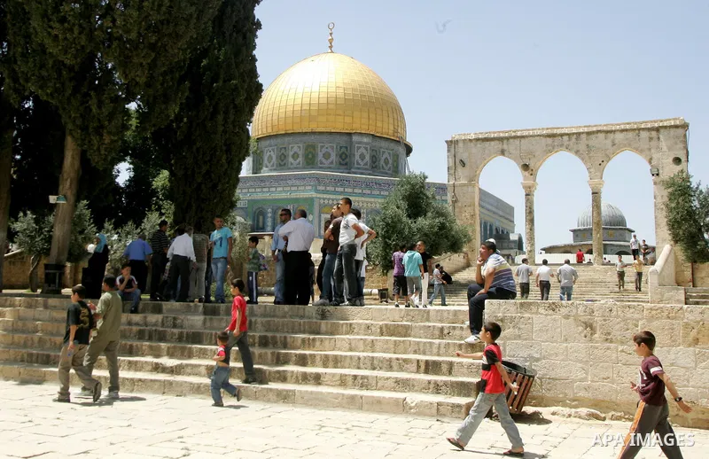 Palestinian Muslim worshipers walk in front of the Dome of the Rock after Friday prayer at the Al-Aqsa mosque compound in Jerusalem's Old City on June 10, 2011. Photo by Mahfouz Abu Turk