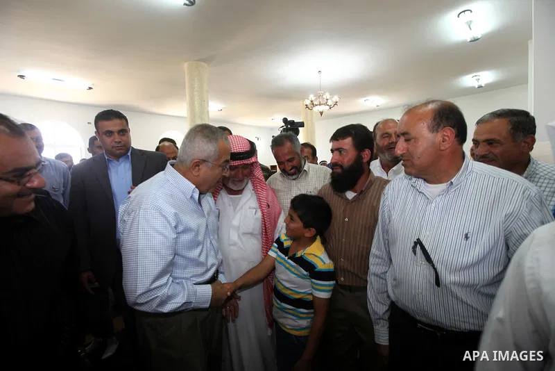 Palestinian Prime Minister, Salam Fayyad attends Friday prayers inside the mosque which was burnt and vandalized mosque by Israeli settlers in the West Bank al-Mughayyir village, some 20 kilometres (12 miles) northeast o...