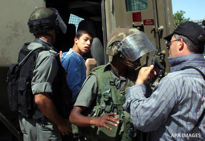 Israeli forces detain a demonstrator during clashes following a protest against the expropriation of Palestinian land, in the village of Nabi Saleh, in the Israeli-occupied West Bank, on June 10, 2011. Photo by Issam Rim...