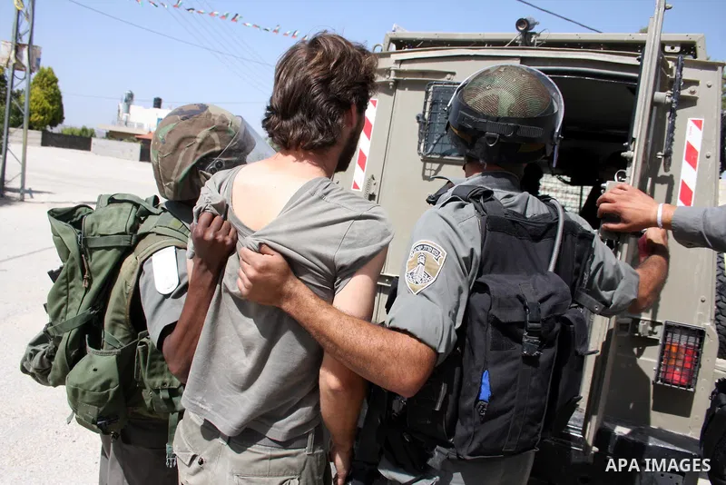 Israeli forces detain a demonstrator during clashes following a protest against the expropriation of Palestinian land, in the village of Nabi Saleh, in the Israeli-occupied West Bank, on June 10, 2011. Photo by Issam Rim...