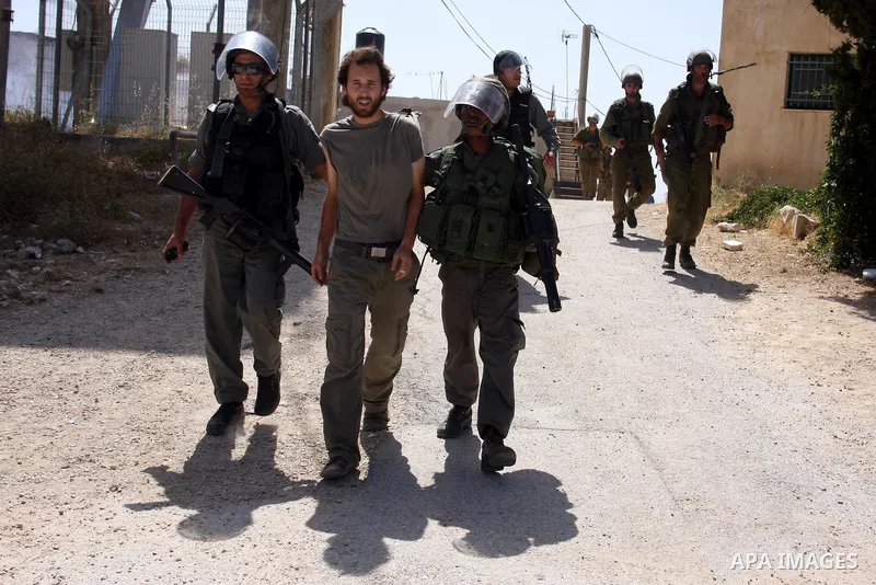 Israeli forces detain a demonstrator during clashes following a protest against the expropriation of Palestinian land, in the village of Nabi Saleh, in the Israeli-occupied West Bank, on June 10, 2011. Photo by Issam Rim...