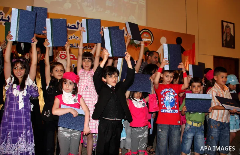 Palestinian children participate in the graduation ceremony at their kindergarten in the West Bank city of Nablus on June 12,2011. Photo by Wagdi Eshtayah