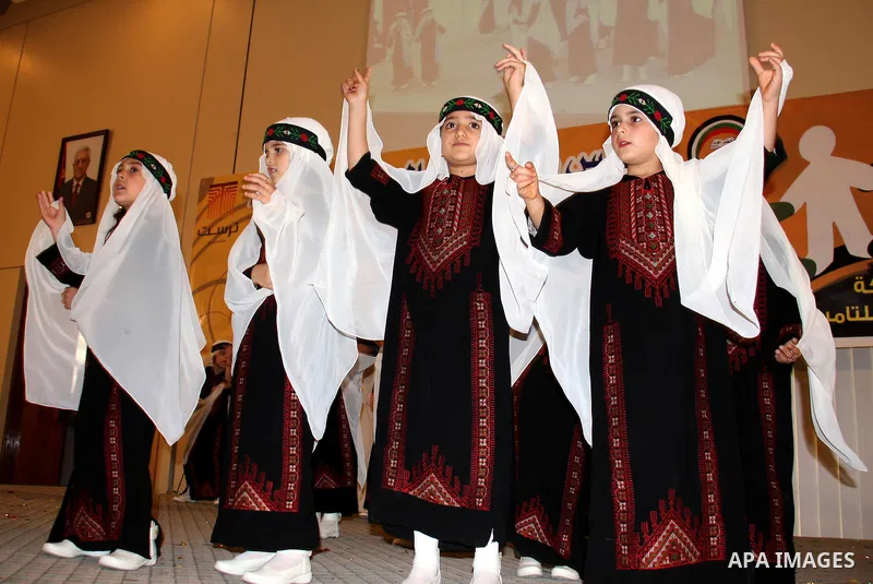 Palestinian children participate in the graduation ceremony at their kindergarten in the West Bank city of Nablus on June 12,2011. Photo by Wagdi Eshtayah